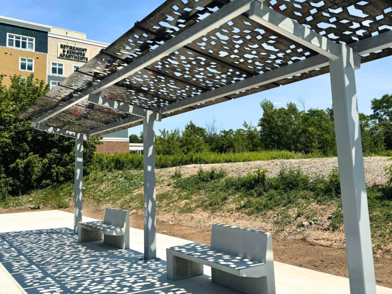 Photo of the shade structure and concrete bench.