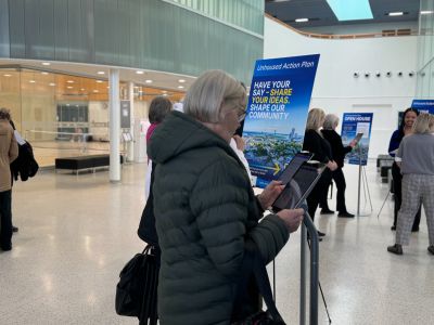 Photo of an individual completing an online survey on an iPad.