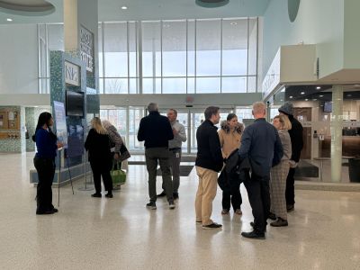 Image of residents and staff talking in the MacBain Community Centre Lobby at the Open House